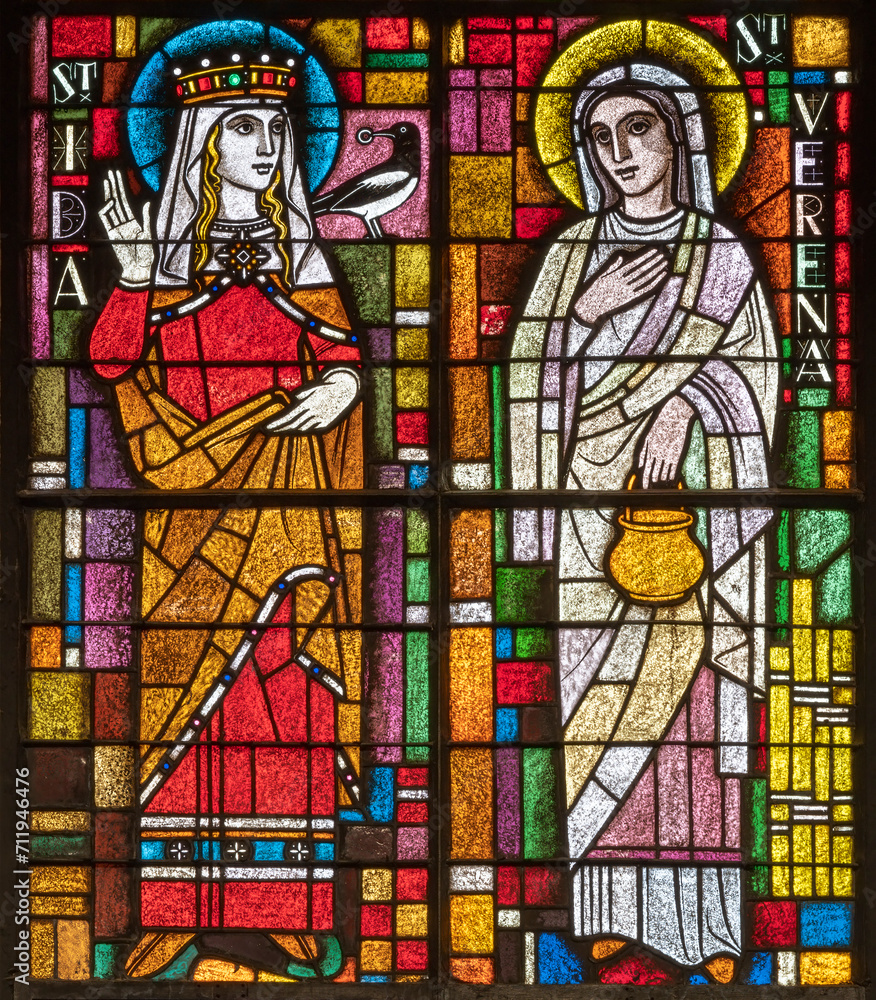 BERN, SWITZERLAND - JUNY 27, 2022: The St. Verena and St. Ida on the stained glass in the church Dreifaltigkeitskirche by A. Schweri (1938).