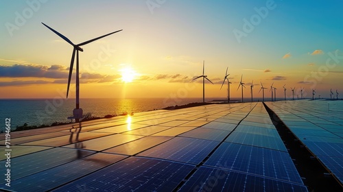 A serene sunset over the ocean with silhouette of wind turbines and solar panels, depicting renewable energy harnessing.