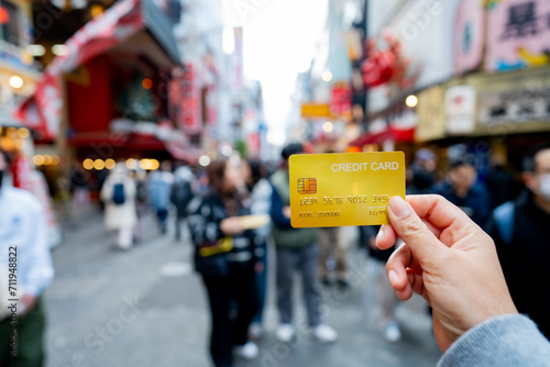 Tourist woman showing credit card or travel card for convenient travel Make shopping easy enjoy lifestyle travel city at shopping street on holiday vacation in Japan