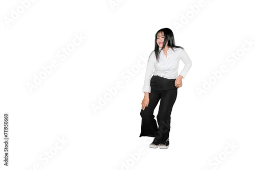 Young businesswoman dancing with silly movement in the studio