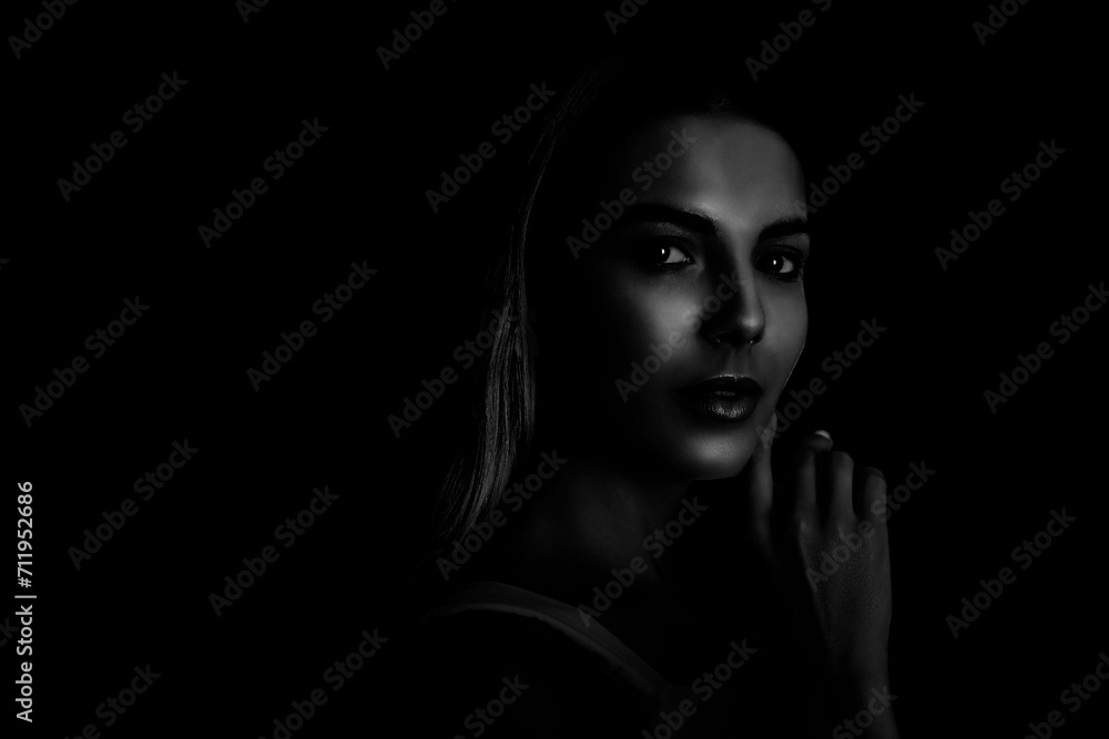Silhouette of woman in darkness. Portrait on black background