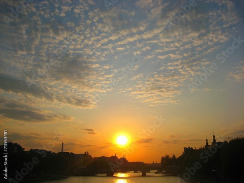 Sunset, Eiffel Tower and Paris cityscape silhouette at the bridge on Seine river in Paris, France