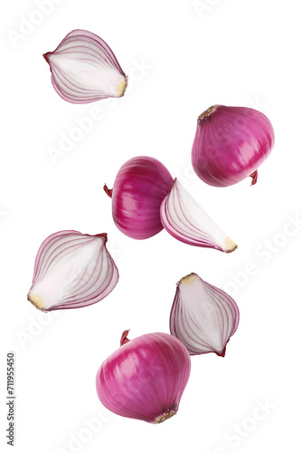Red onion bulbs falling on white background