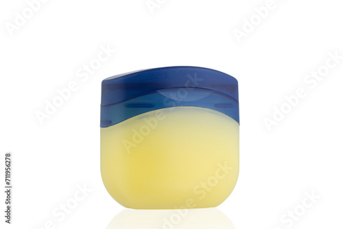 Vaseline Bottle on a white background. 
Jar for petroleum jelly. 
Yellow plastic container with blue lid.