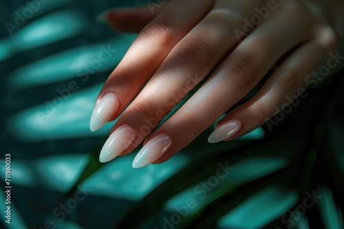 Ombre manicure on tropical leaf background