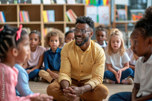 Enthusiastic teacher giving a to class full of diverse children photo