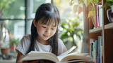 Asian child reading book at home