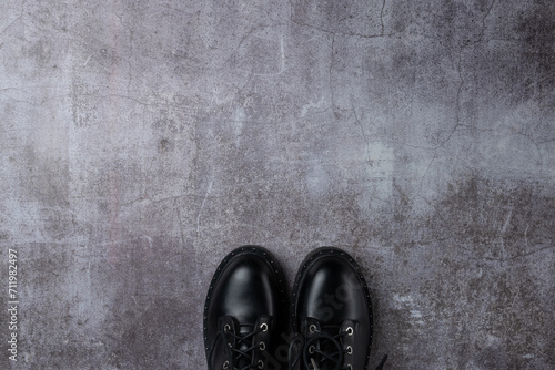 Gray background with pair black boots photo