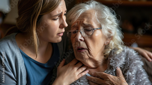 Senior woman suffering, clutching, and having difficulty breathing, chest pain, or heart attack daughter help and support her mother, life, and living insurance