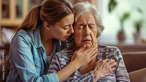 Senior woman suffering, clutching, and having difficulty breathing, chest pain, or heart attack daughter help and support her mother, life, and living insurance photo