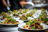 Many plates of vegetable salad in commercial kitchen