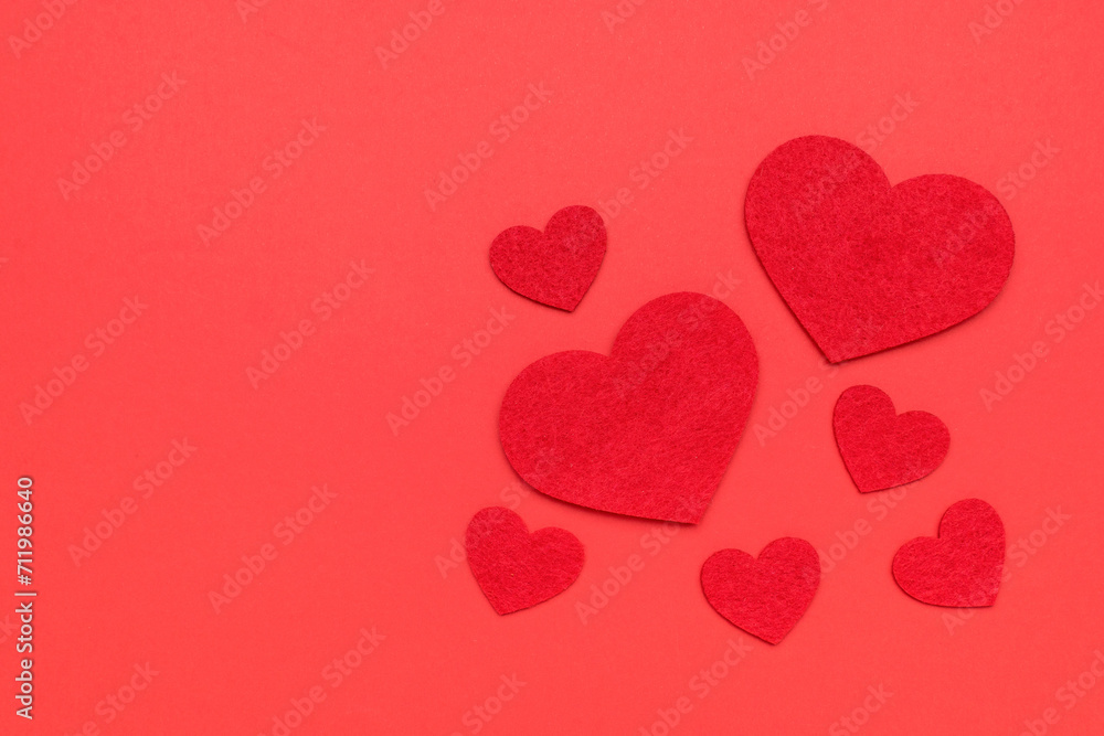 Red carved hearts on a bright red background.