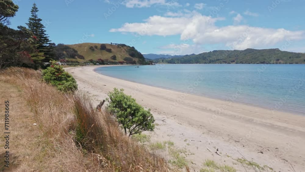 Calm sandy beach and turquoise ocean. Otautu Bay, Coromandel Peninsula, New Zealand. Calm sandy beach and turquoise ocean. Otautu Bay, Coromandel Peninsula, New Zealand.