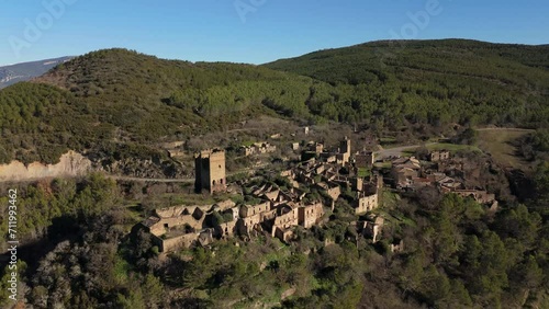 General drone moving away movement of the abandoned village of Ruesta, Spain photo
