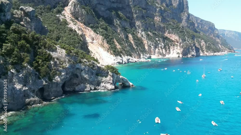 Cala Goloritze shore crowded with boat tourism, Sardinia. Aerial Cala Goloritze shore crowded with boat tourism, Sardinia. Aerial