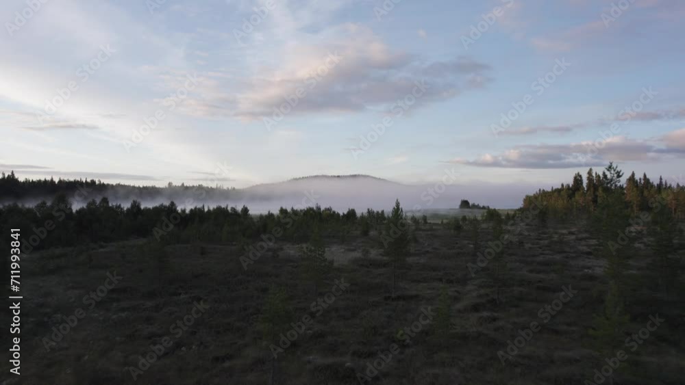 Norwegian forest landscape with morning fog over distant lake AERIAL SHOT Norwegian forest landscape with morning fog over distant lake AERIAL SHOT