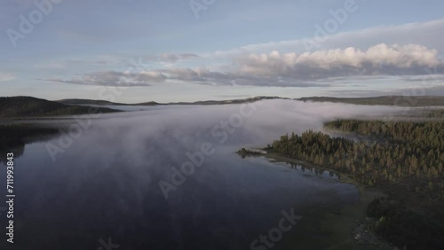 Morning fog over tranquil lake reflects forest Norwegian landscape DRONE  photo