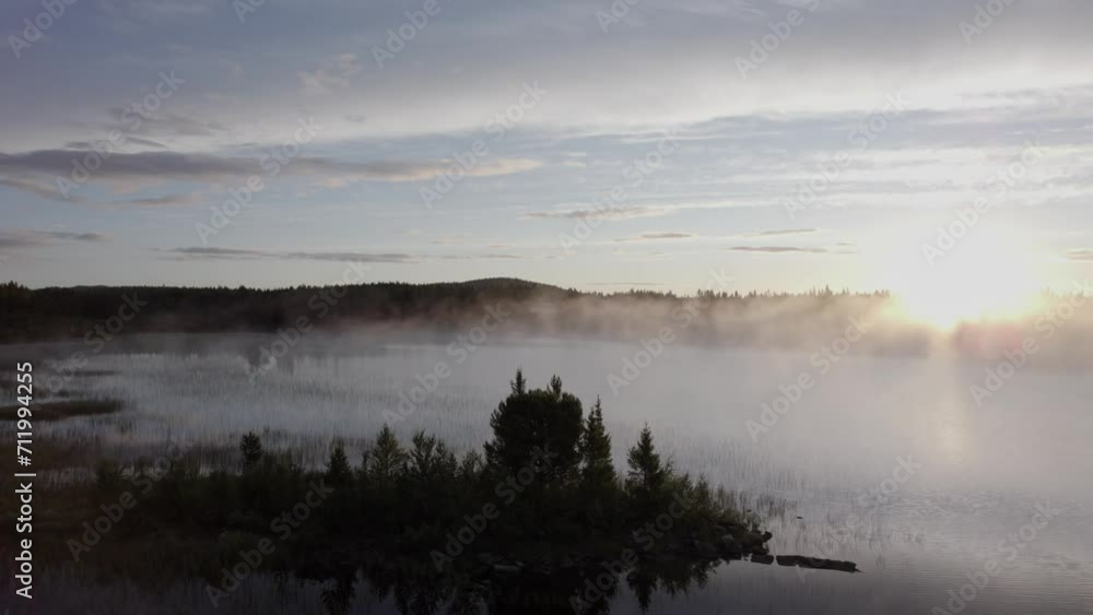 Eerie morning sunrise mist over tranquil forest lake Norway landscape DRONE Eerie morning sunrise mist over tranquil forest lake Norway landscape DRONE