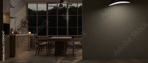 Fototapeta Naklejka Na Ścianę i Meble -  A modern spacious dark kitchen at night with an empty wall mockup.