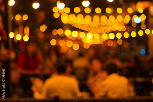 blur image of night festival in a restaurant and The atmosphere is happy and relaxing with bokeh for background
