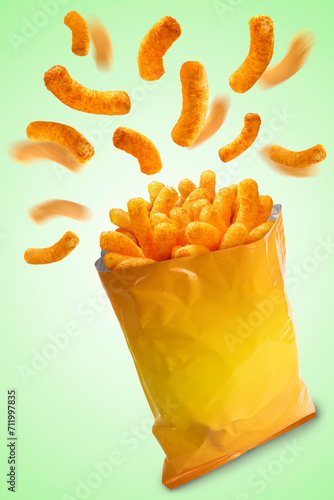 Puffed corn snacks cheesy chips fly out of plastic snack bags isolated on green background, Puff corn or Corn puffs cheese flavor on green, With clipping path.