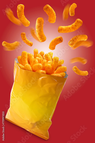 Puffed corn snacks cheesy chips fly out of plastic snack bags isolated on red background, Puff corn or Corn puffs cheese flavor on red With clipping path.