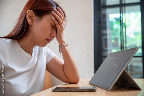 Stressed businesswoman feeling hopeless with stock market crisis, investment concept