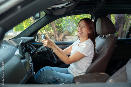 Beautiful young woman happy with car smiling showing tooth