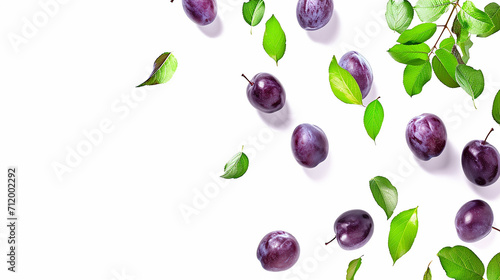 Plums with green leaves falling on the white background