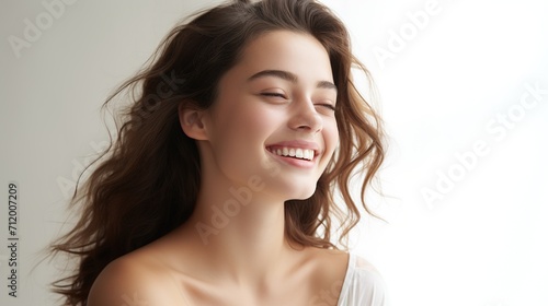 Portrait of a beautiful young woman smiling with her eyes closed