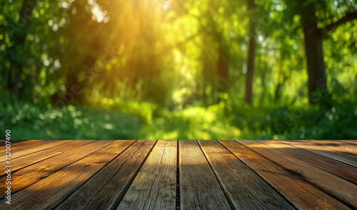 Wood floor with blurred trees of nature park background and summer season  product display montage.