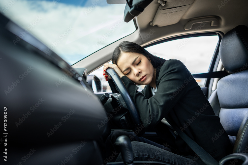 Young asian businesswoman driver was drowsy. She yawned and was about to fall asleep in car doze off. Driving for a long time sleep deprivation. Campaign for safe driving Young asian businesswoman driver was drowsy. She yawned and was about to fall asleep in car doze off. Driving for a long time sleep deprivation. Campaign for safe driving