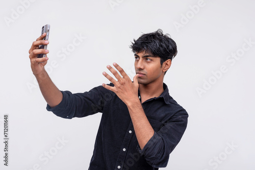 Young man taking a selfie with smartphone