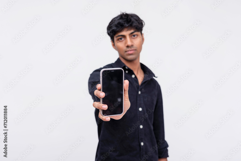Young man presenting smartphone with blank screen Young man presenting smartphone with blank screen