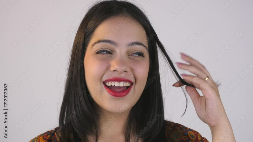 Funny Indian young woman playing with her hair - facial expressions ...