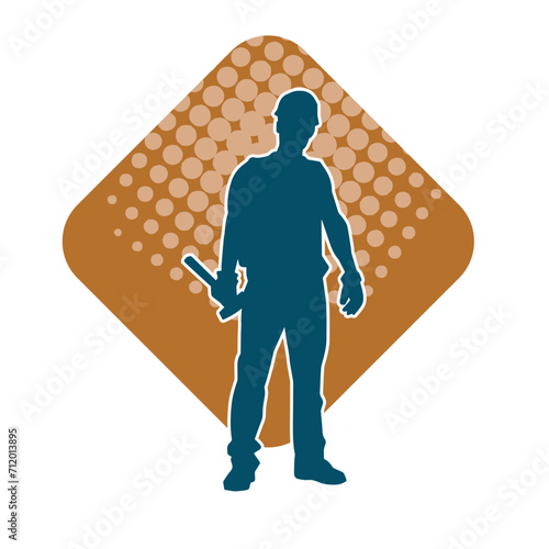 Silhouette of a worker carrying hammer tool. Silhouette of a worker in action pose using hammer tool.