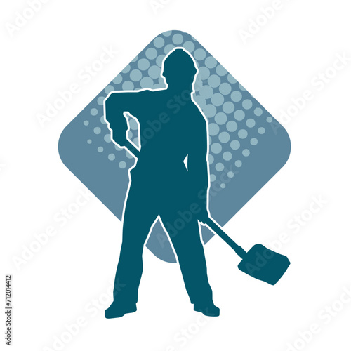 Silhouette of a worker carrying shovel tool. Silhouette of a worker in action pose using shovel tool.