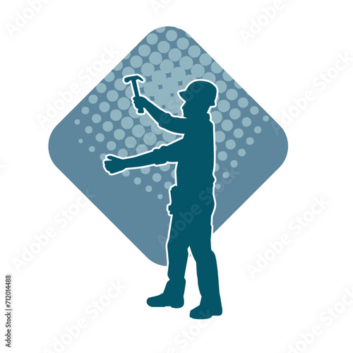 Silhouette of a worker carrying hammer tool. Silhouette of a worker in action pose using hammer tool.
