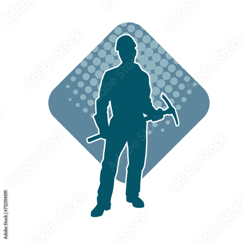 Silhouette of a man in worker costume carrying pick axe tool in action pose. Silhouette of a miner in action pose with pick axe tool.