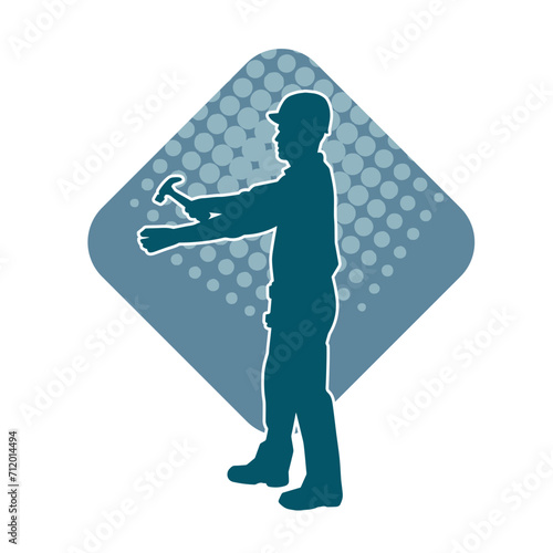 Silhouette of a worker carrying hammer tool. Silhouette of a worker in action pose using hammer tool.