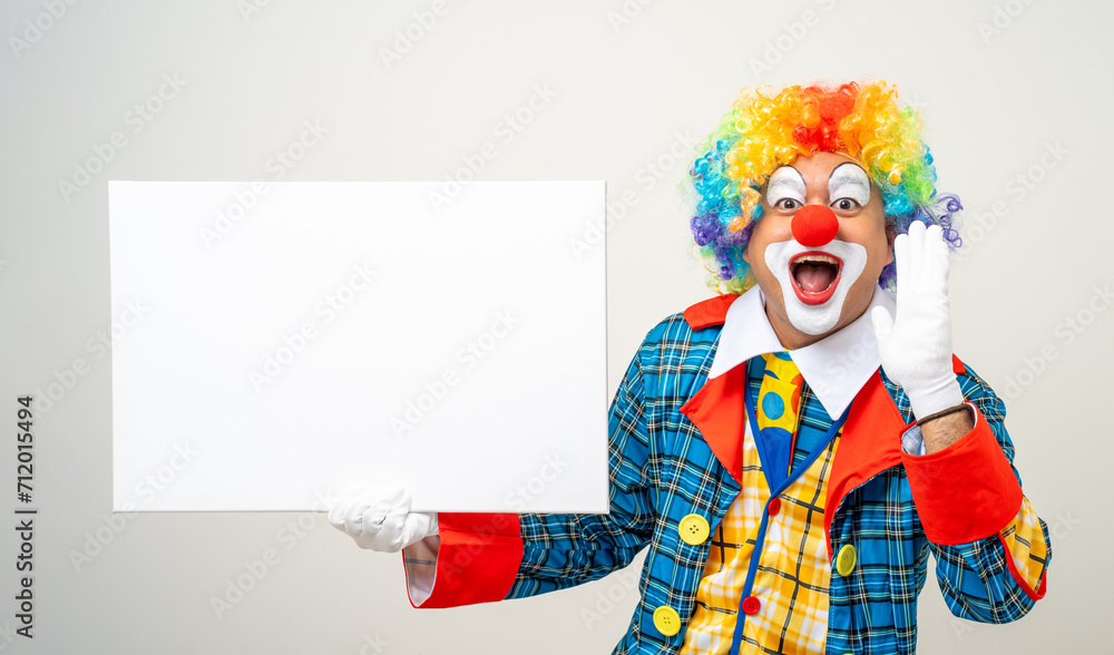 Mr Clown. Portrait of Funny face Clown man in colorful uniform standing holding copy space. Happy expression male bozo in various pose with frame mockup blank space on isolated background.
