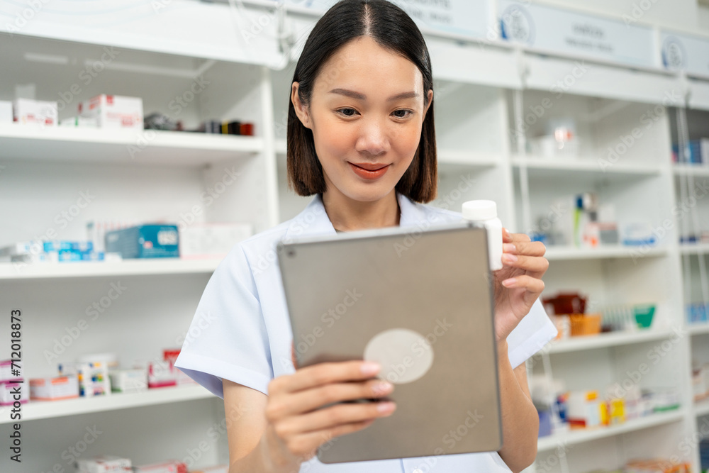 Professional Pharmacist woman in uniform holding medicine bottle talks to patient via online video conferencing advice to customers standing near drug shelves counter. Pharmacist inventory medicine