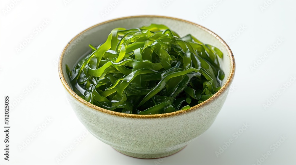 close-up of a bowl of Wakame Seaweed on a White Background. close-up of a bowl of Wakame Seaweed on a White Background.