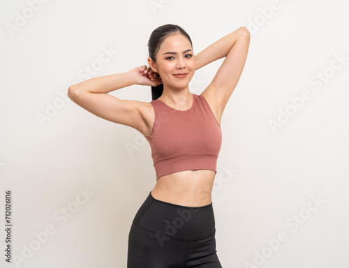 Young beautiful smiling asian woman with sportswear on isolated white background. Portrait happy healthy slim fit and firm latin attractive sporty woman standing pose exercise workout in studio. © Chanakon