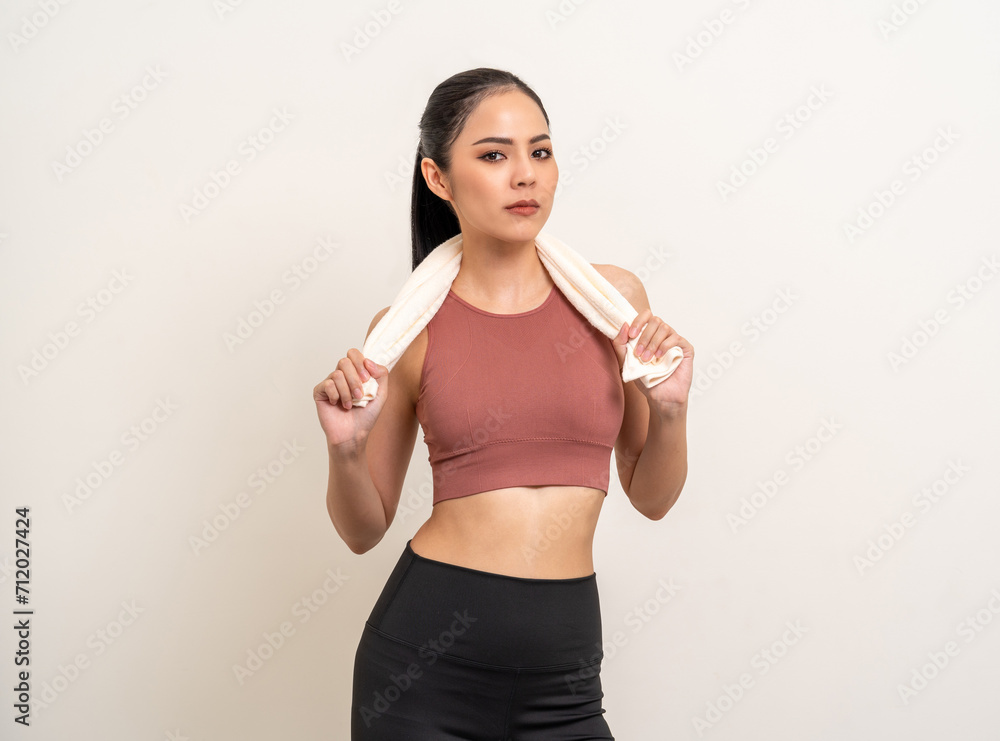 Young beautiful smiling asian woman in sportswear with towel on isolated background. Portrait happy healthy slim fit and firm latin attractive sporty woman standing pose exercise workout in studio. Young beautiful smiling asian woman in sportswear with towel on isolated background. Portrait happy healthy slim fit and firm latin attractive sporty woman standing pose exercise workout in studio.