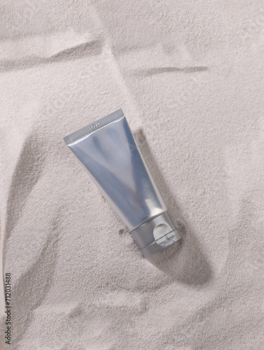unmarked brand tube product on sand