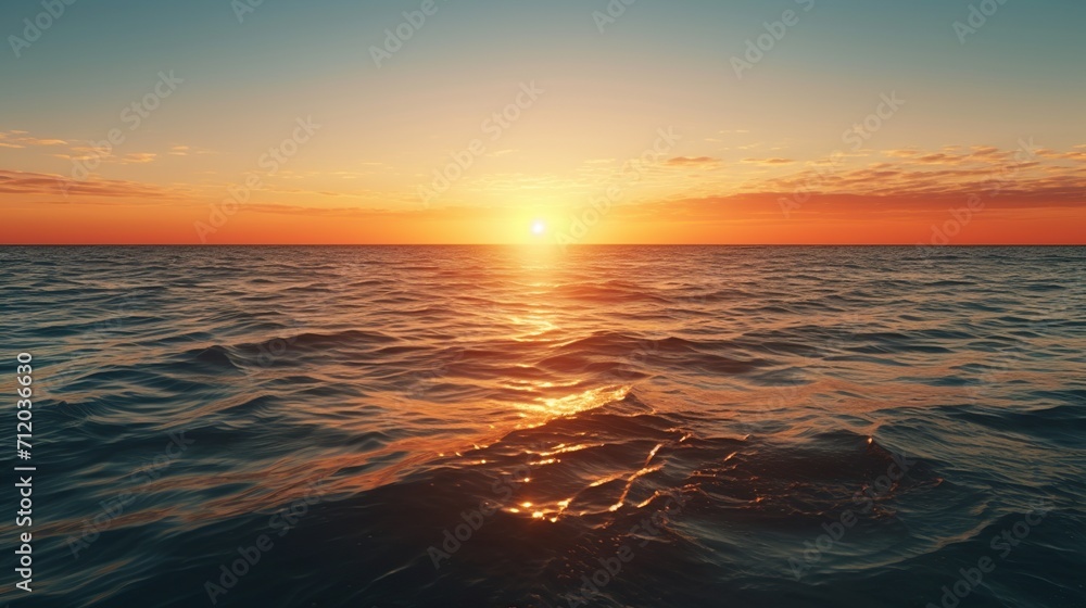 view of sunrise across ocean towards horizon with clouds in colorful sky in background