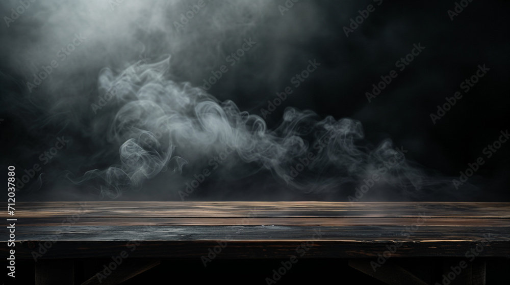 On a black background, an empty wooden table with smoke floats up. Empty space for displaying your products, with a smoke float up on a dark background. 