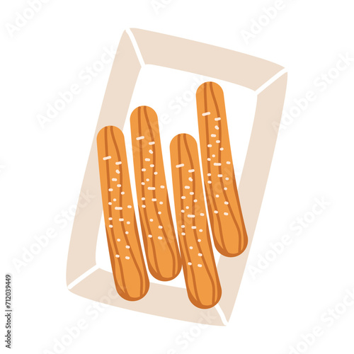 Churros sticks in paper bag with sugar powder