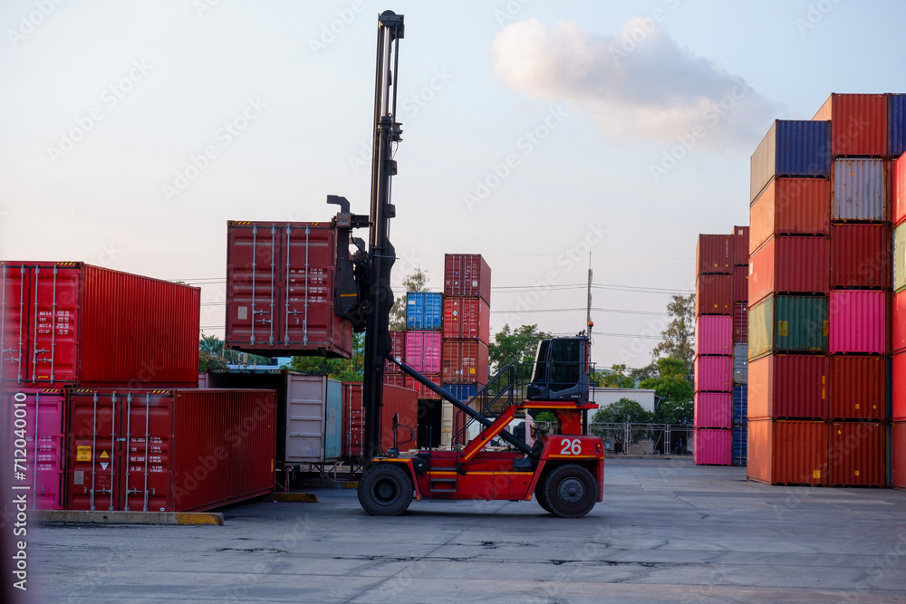 Container truck in a shipping yard with stacks of colorful containers Copy space background, logistics, import, export, freight forwarder and transportation industry concept.